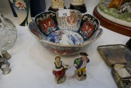 A Japanese 19th century Imari bowl and two small German figures
