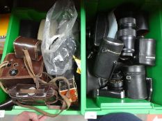 A large quantity of cameras, lenses, a tripod, books, etc