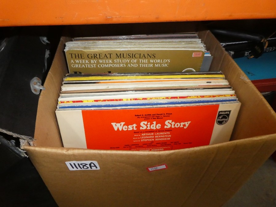 A box of records and two thin cases of records