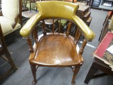 An Early 20th Century mahogany desk chair having a moulded seat and leather back