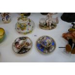 A Meissen floral encrusted cup cover and saucer decorated birds, two other Dresden style examples an