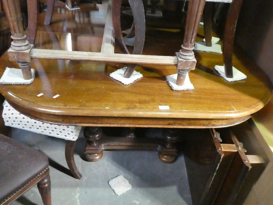 French walnut oval extending table with two leaves and 6 bar back mahogany dining chairs with red an