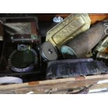 A small wooden and iron band case containing brass shell vases, vintage tape measures, wooden plaque