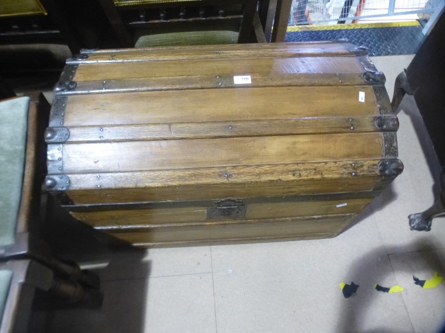 A large wooden chest with metal handles and bound metal top