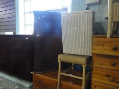 A wooden corner cupboard, Lloyd Loom style basket and stool