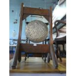 Bronze dinner gong hung in wooden frame