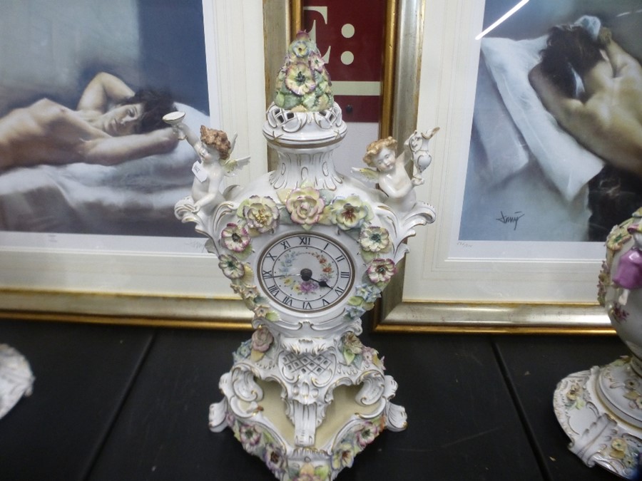 20th Century German porcelain clock garniture having floral encrusted and figural decoration, the cl - Image 2 of 4