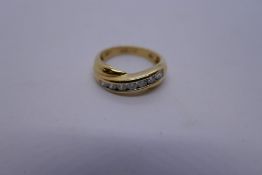 18K yellow gold crossover design ring set with 7 diamonds, approx 0.5 CARAT, marked 750, weight 5g