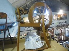 A wooden spinning wheel and accessories