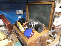 A wooden case containing camera, wooden shield plaques, books, etc