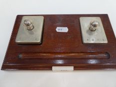 An interesting silver paperweight and silver desk blotter, on a wooden base, hallmarked Birmingham 1