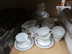A box of vintage Pyrex including cups, gravy boats, etc