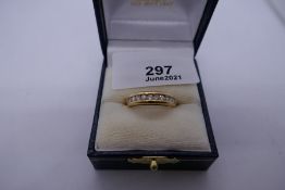 18ct yellow gold band, set with 12 channel set brilliant cut diamonds, size L/M, marked 750, 4.8g