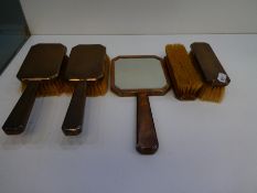 A dressing table set with silver backed, engine turned design, consisting of a mirror and four brush