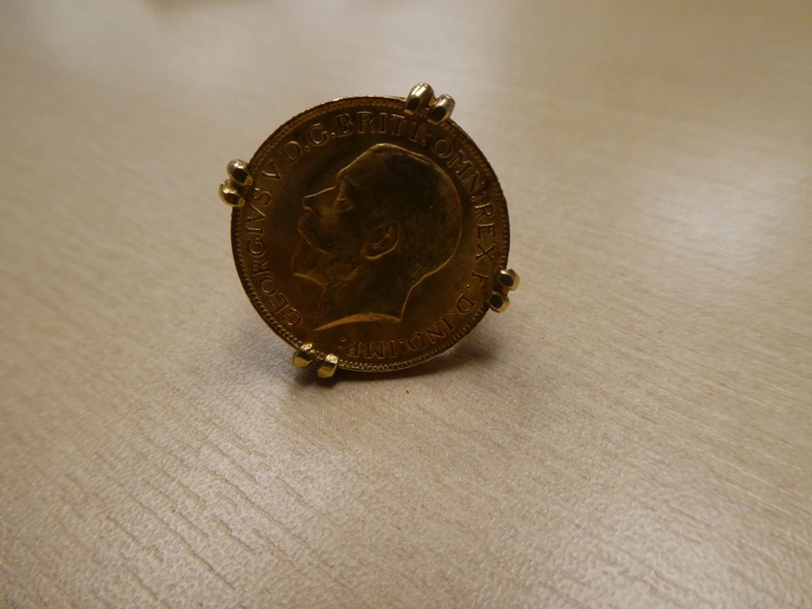 1927 Full sovereign mounted in a yellow metal ring, unmarked, 13.4g