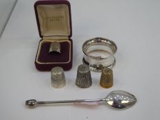 A mixed lot of a thimble hallmarked silver, a silver napkin ring other thimbles and white metal deco