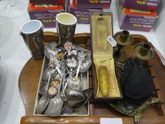 A collection of brassware including stirrup cups, candlesticks and souvenir spoons