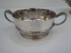 A very interesting and heavy two handled silver bowl with dragon handles and large base. Very decora