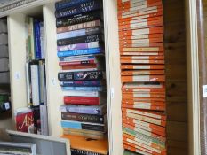 A selection of hard and paperback books on various subjects including Penguin, etc