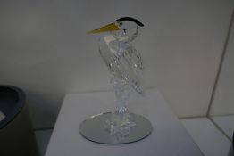 A Swarovski crystal silver heron, retired 2007 and a figure of Dolphin and waves