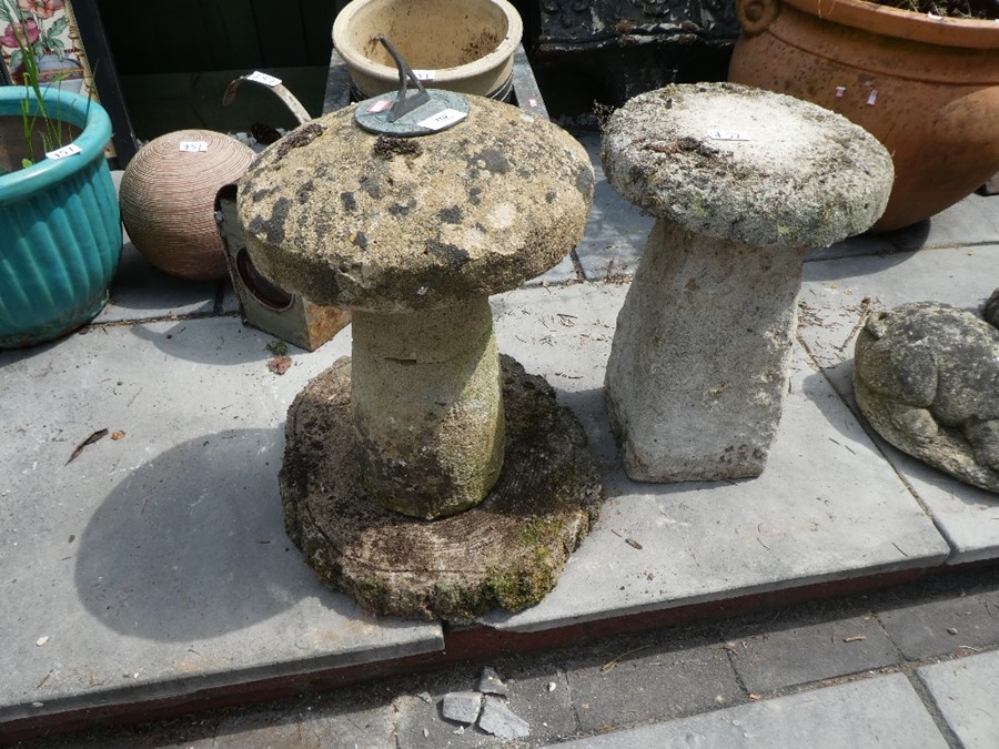 Two miniature stone effect staddle stones, one with a sundial