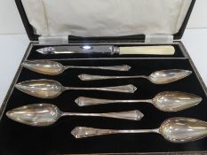 A set of six silver grapefruit spoons hallmarked Birmingham 1941, Lanson Ltd, along with a stainless