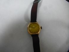 Vintage unmarked yellow metal wristwatch on fabric strap by Record
