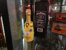 Two bottles of alcohol, including Jack Daniels and Lanson Champagne