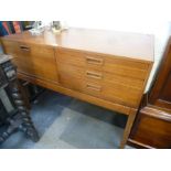 A 1970s sideboard having three drawers with cupboard, 120cms