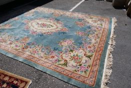 A large Chinese green carpet having all over floral design 372x270cm