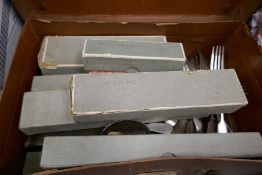 A box of silver plated items and a small suitcase of cutlery