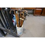 A quantity of walking sticks and similar, some silver decorated in an oriental stickstand