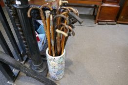 A quantity of walking sticks and similar, some silver decorated in an oriental stickstand
