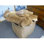 A box of fur coats, cushions and similar items