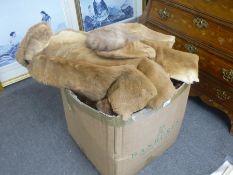 A box of fur coats, cushions and similar items