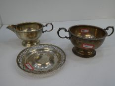 A silver porringer with beaded rim and pot, with pedestal base. Two handled, hallmarked Birmingham 1