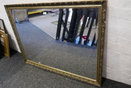 A large modern gilt framed mirror