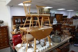 An Ercol light oak 2 flap kitchen table and a set of 4 Ercol Shalstone chairs