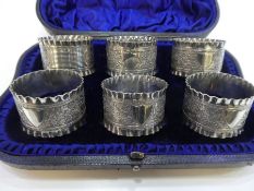 A quantity of six plate napkin rings, very nice items, cased with ornate, decorative design and scal