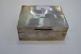 A silver patterned cigarette box 11cm x 9cm x 5cm, hallmarked London 1929 Cornelius Desormeaux Saund