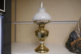 A Victorian brass oil lamp, having engraved decoration