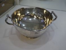 A very large, heavy silver fruit bowl with two handles, on a slight raised pedestal base, hallmarked