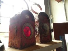 Two hanging vintage lanterns with red round perspex panels