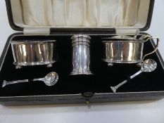 A silver cruet set comprising of salts, pepper and small spoons, salts with a Bristol blue insert, h