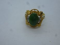14L yellow gold ornate design ring set with oval green hardstone, possibly Jade and 4 small diamonds