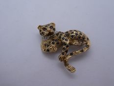 9ct yellow gold brooch in the form of a leopard inset with sapphires, red stones marked 375, 10.4g a