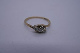 9ct yellow gold crossover design ring set with 3 diamonds in Platinum mount marked '9ct and Plat' si