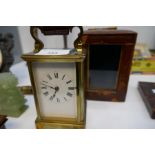 An old brass carriage clock with tatty leather case