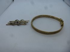 9ct tri gold design bangle marked 9kt, AF misshapen and 9ct brooch with central red stone, marked 9c