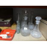 A selection of glass decanters and vintage bottles, etc and books